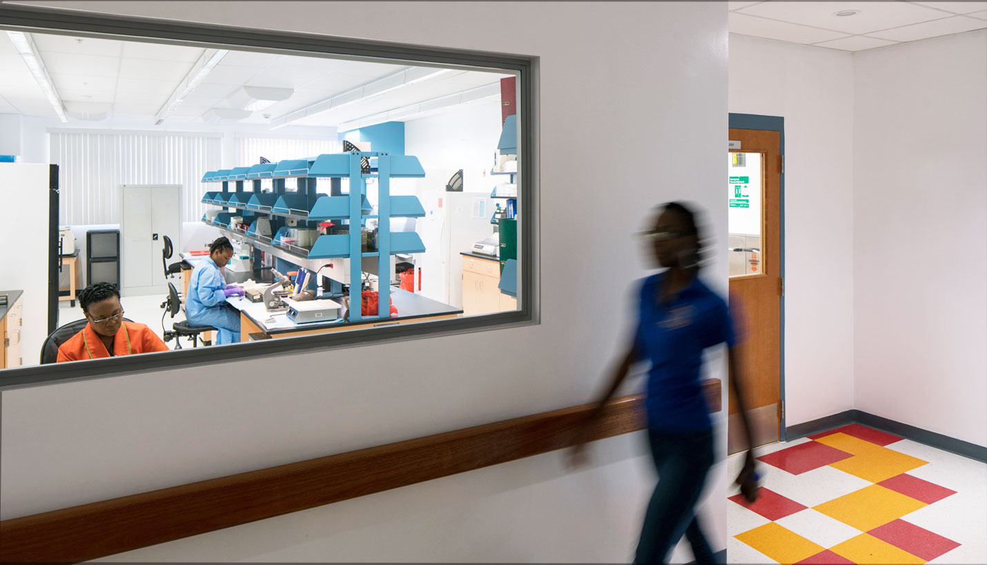 The Barbados National Medical Reference Laboratory is rated for Biological Safety Level 2 per CDC standards. An employee passes by a secured-access laboratory. - Jacob Krupnick, Wild Combination Photography