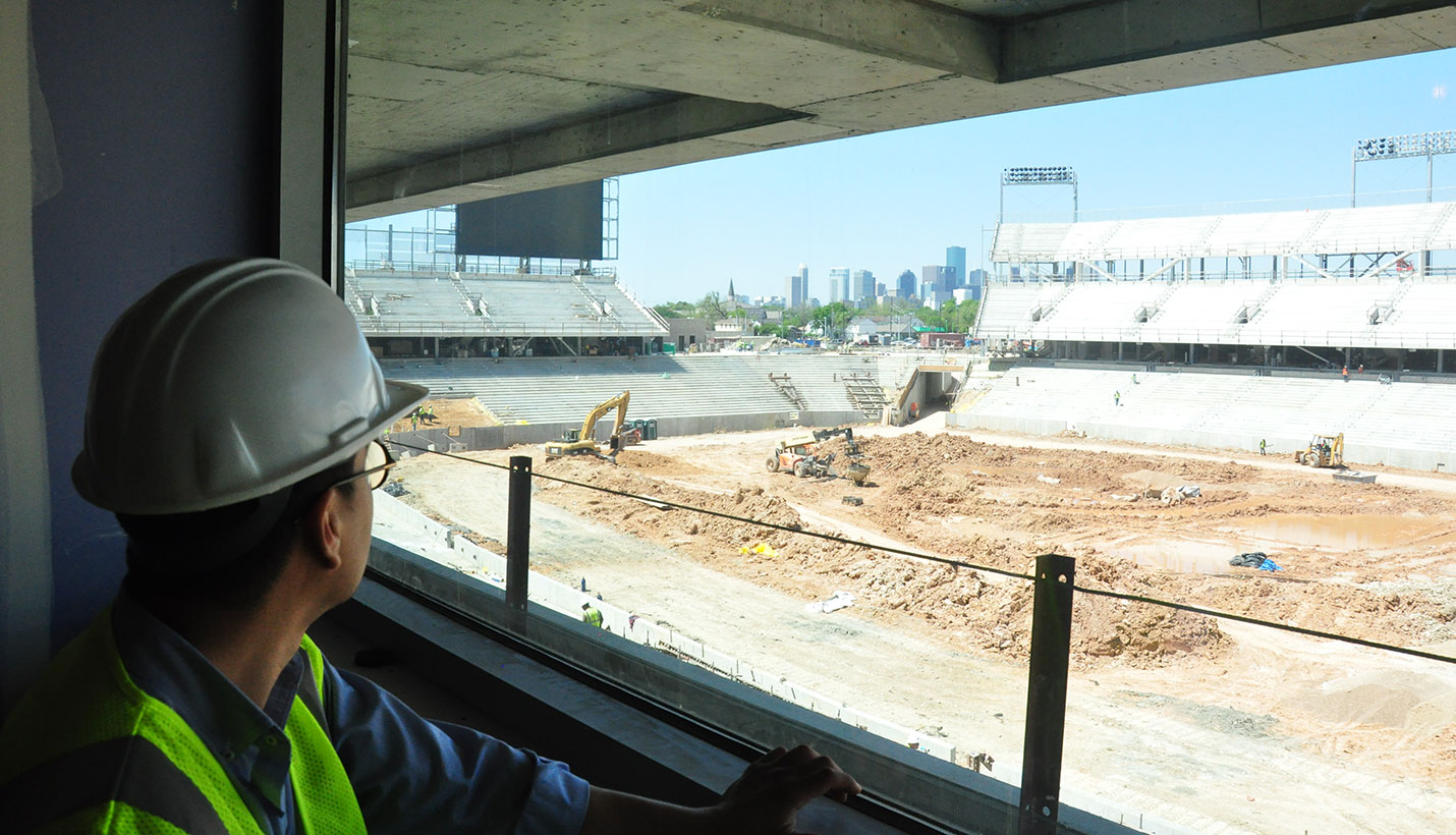 Beneath The Walls: An architecture student contemplates the view of downtown Houston skyline from the upper level suites. (07/25/2014) - Page