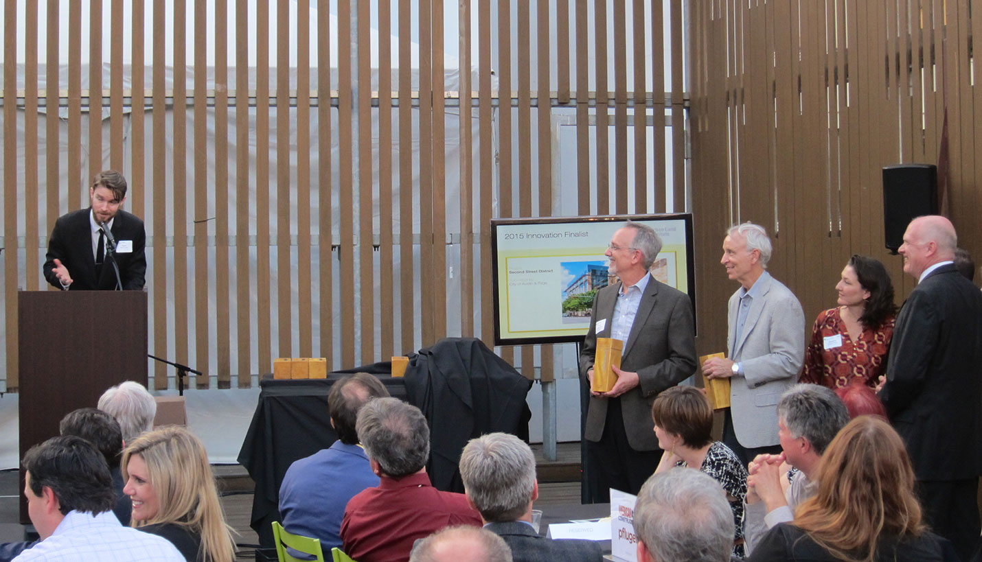 Page Senior Principal Larry Speck, second from left, stands with the 2nd Street District project team as they accept a ULI Austin Impact Award. - 