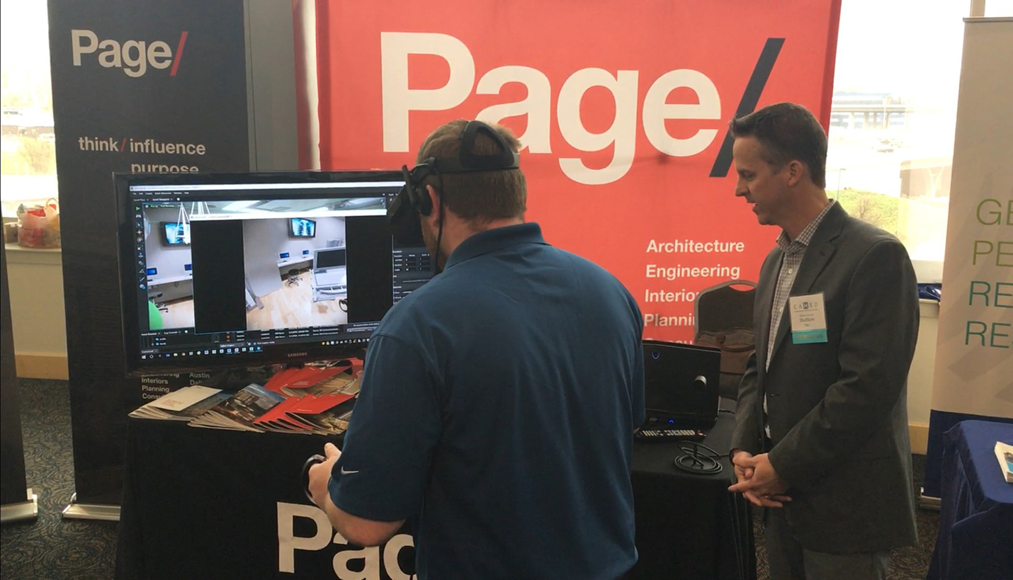 Page Associate Principal Matt Edmonds (right) shows a volunteer how to use a Virtual Reality (VR) headset and controllers to explore an operating room during the design phase. - Page